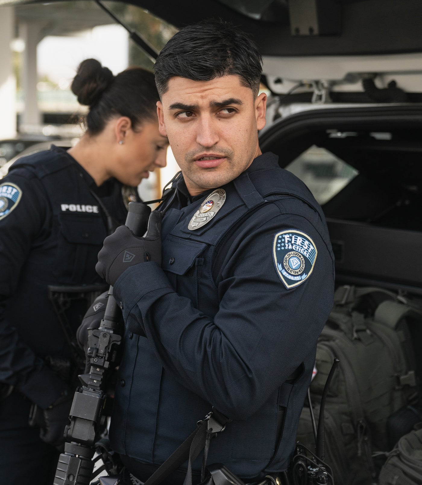 Man in V2 Pro Performance Shirt in Midnight Navy and gloves holding rifle.